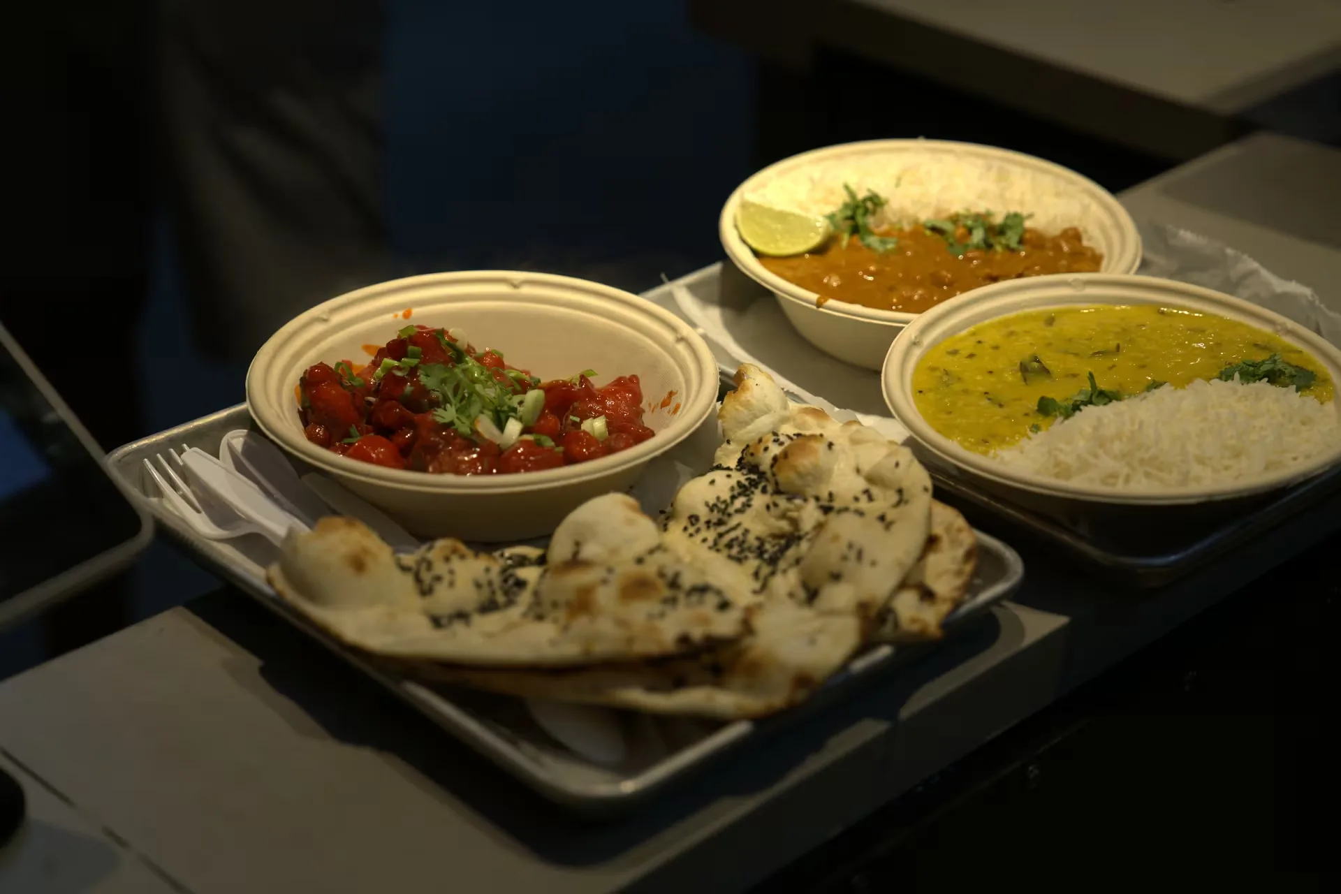 Curry bowls served with fresh naan